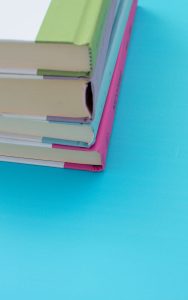 Stack of colorful books on a blue background